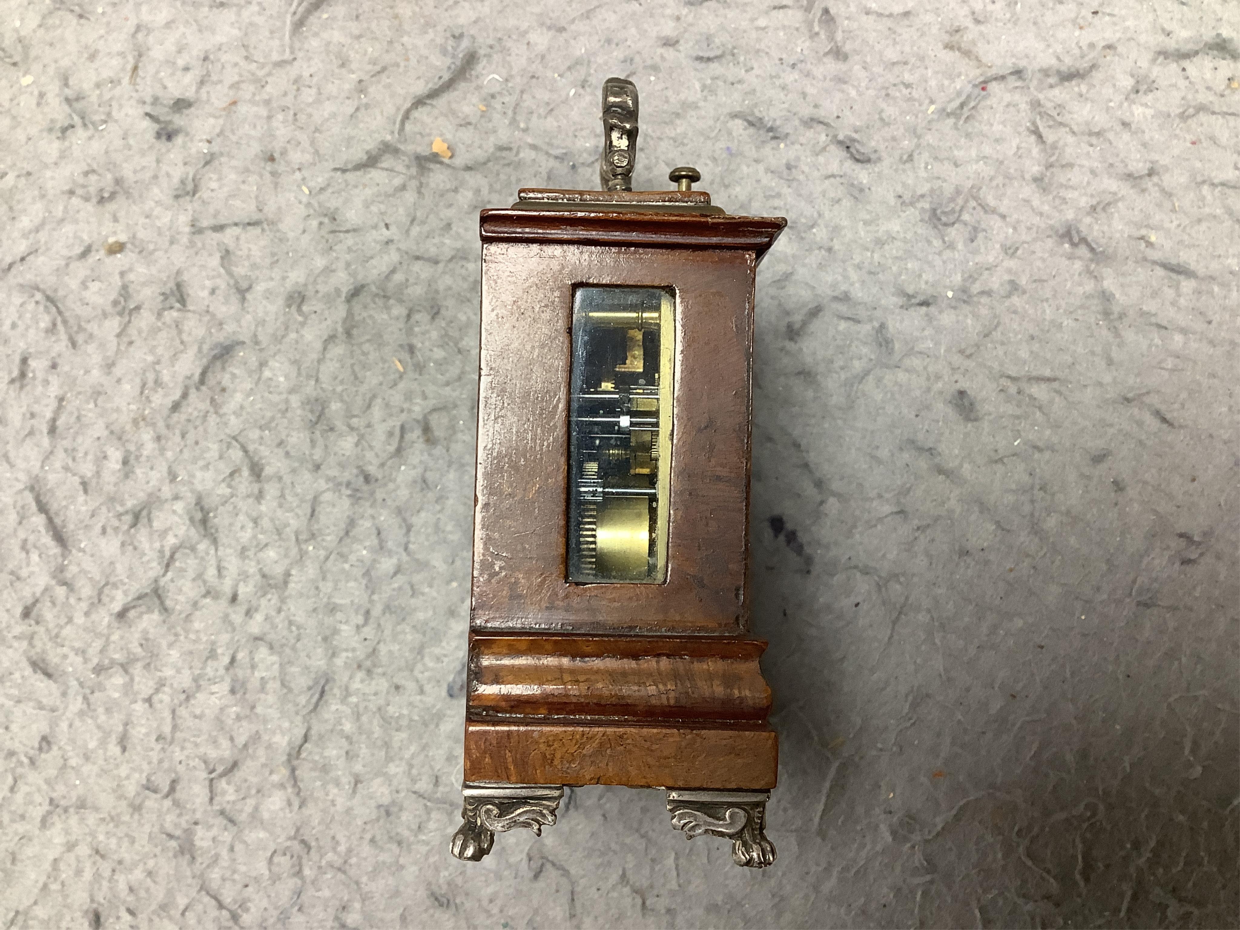 An early 20th century walnut miniature repeating carriage clock, with key, 8.5cm. Condition - fair, currently ticking